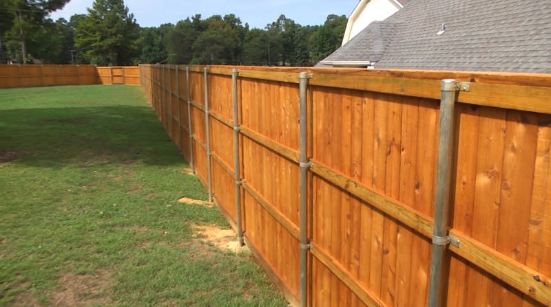 Wood fence with metal posts.